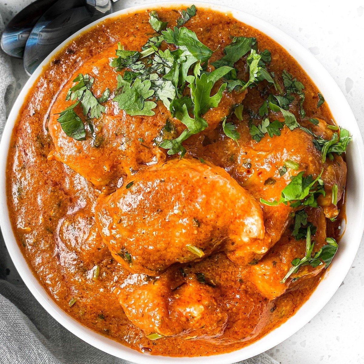 Brown Gravy Base served in bowl beside fresh herbs